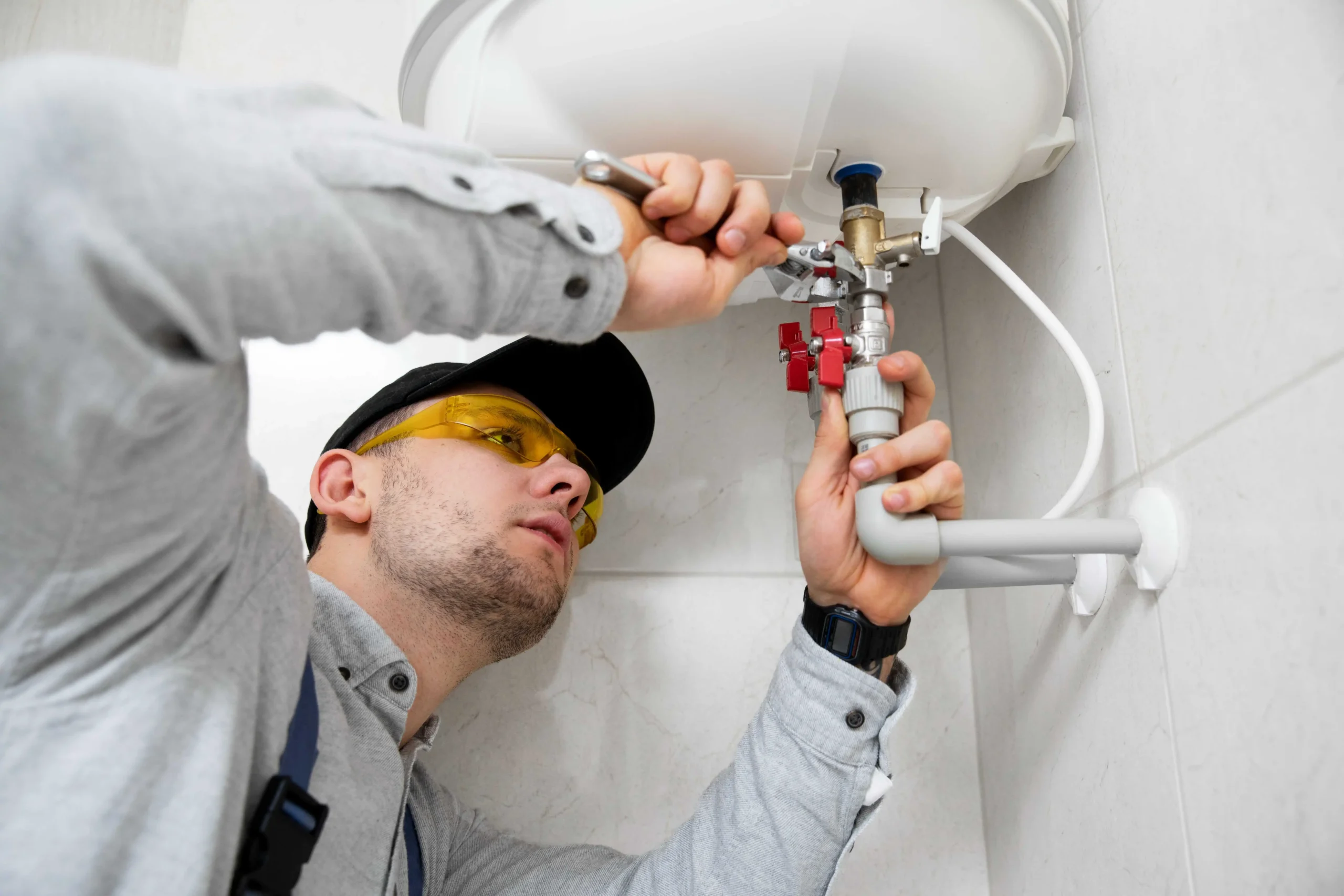 A worker-repairing-water-heater provided by Eco Free Boiler Grant